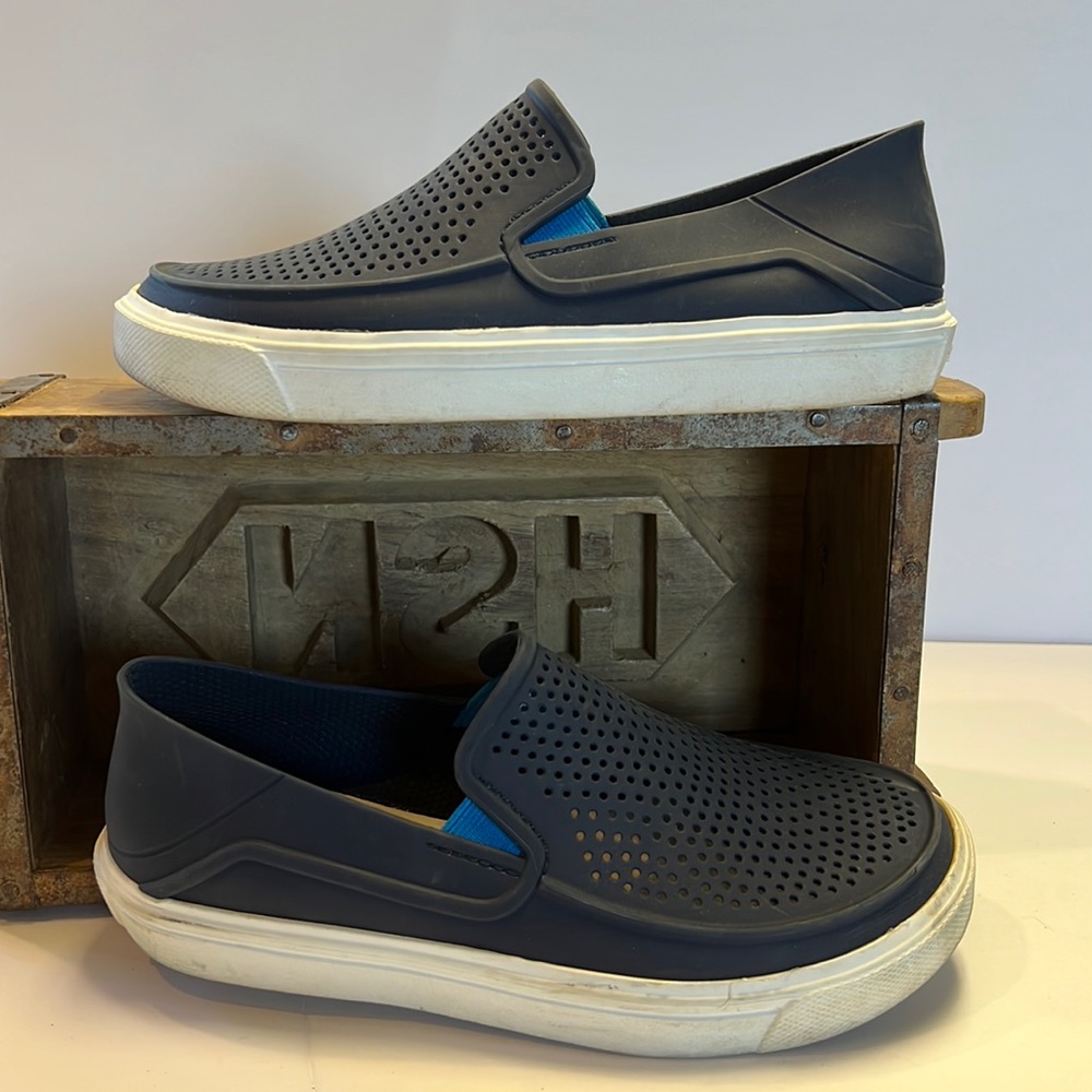 Croc brand slide on shoes.